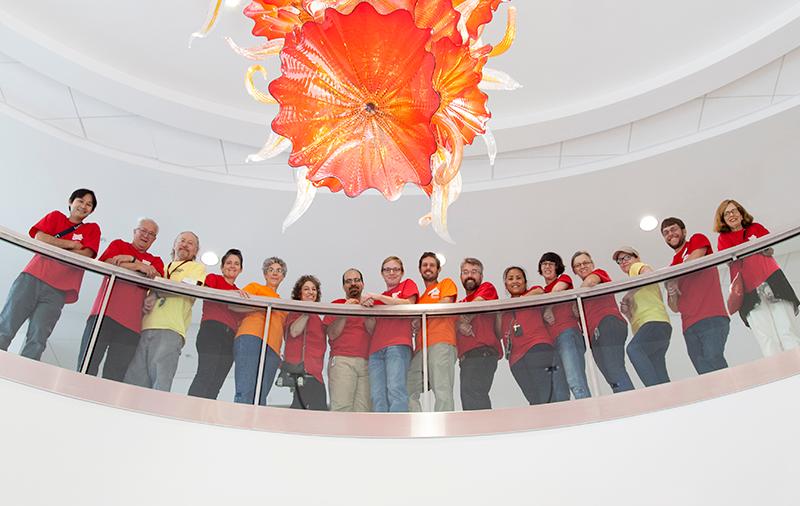 Group of faculty and staff under a chandelier