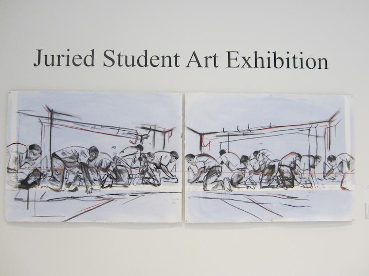 Juried Student Art Exhibition sign with artwork underneath.
