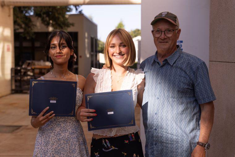 Faculty with two students accepting award