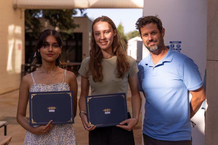 Faculty with two students accepting award
