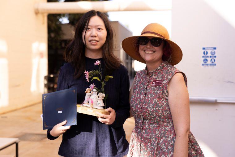 Faculty with student accepting award