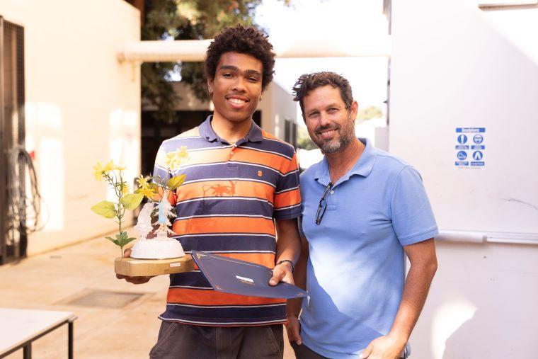 Faculty with student accepting award