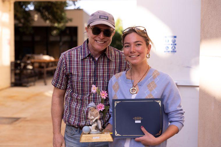 Faculty with student accepting award