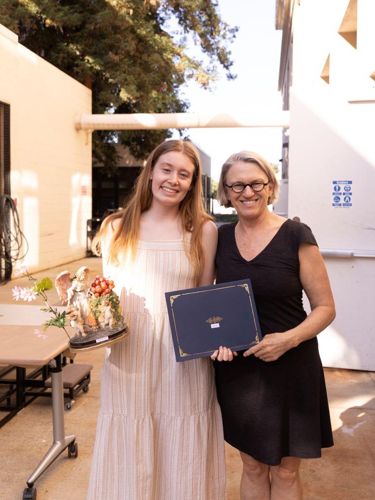 Faculty with student accepting award