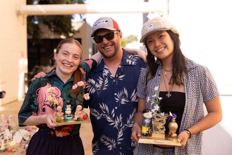 Faculty with two students accepting award