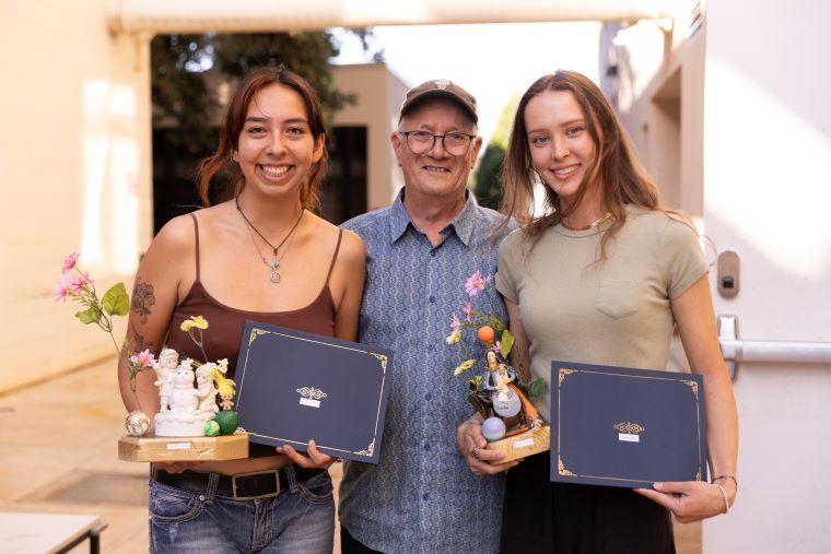 Faculty with two students accepting award