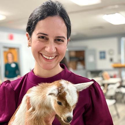 Cathleen Chopra-McGowan holding a kid goat