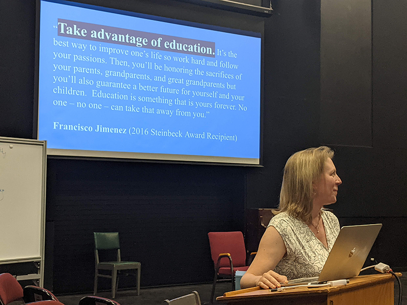 Maria Judnick presenting a slide that says Take advantage of education
