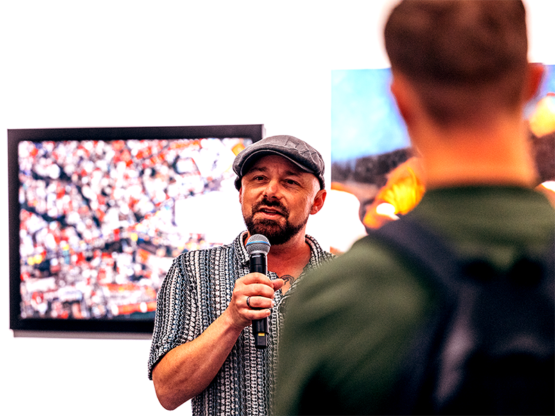 Miah Jeffra speaks to a crowd of exhibit visitors. | Miguel Ozuna