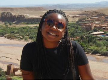 A person smiling with a landscape background in Deja story.