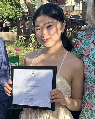 Sam Lei holding her award