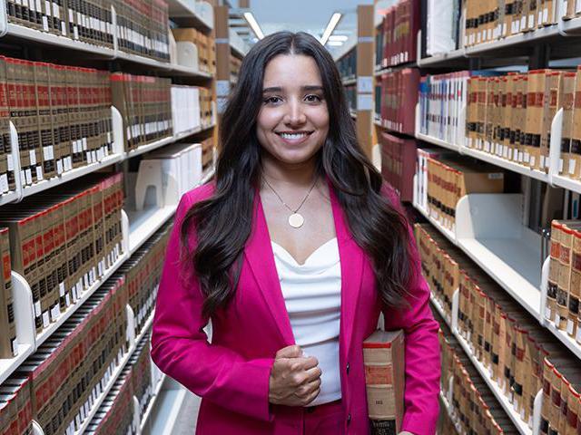 Mirelle Raza in a law library