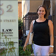 A woman stands next to a LAW office sign.