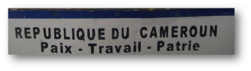 REPUBLIQUE DU CAMEROUN Poste - Travail - Patrie translated to English means REPUBLIC OF CAMEROON Post - Work - Fatherland.

Alt text: Sign with REPUBLIQUE DU CAMEROUN and Poste - Travail - Patrie.