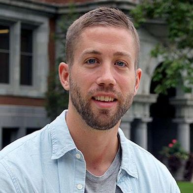 A person in front of a building labeled Tripp Strawbridge.