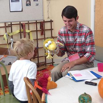 Teacher working with young child 