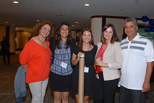 Five people at WPA 2016 event stand together and smile.