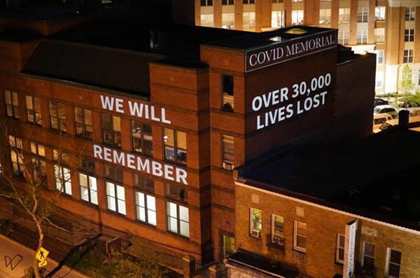 Building with Covid Memorial message lit up at night.