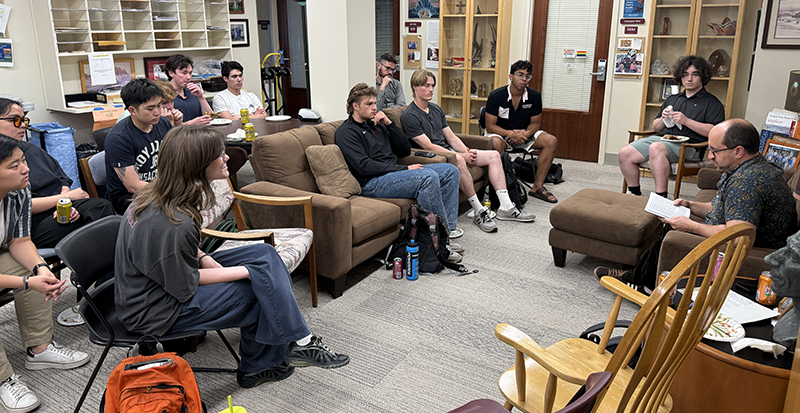 Students gather in the RS office to hear Paul Schutz.