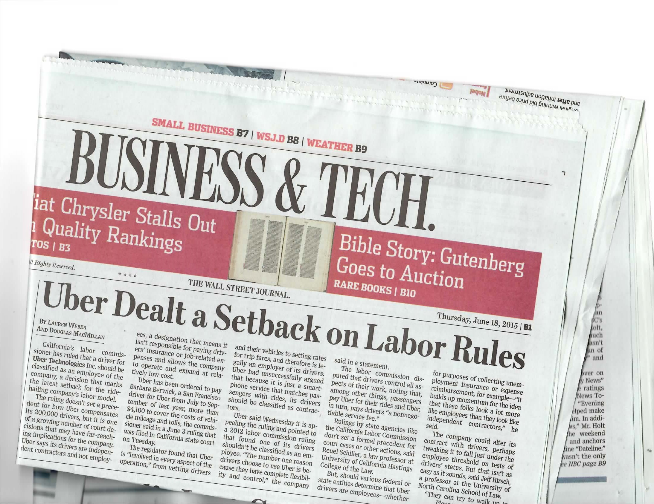Folded Wall Street Journal newspaper with a headline about Ubers labor rules setback.