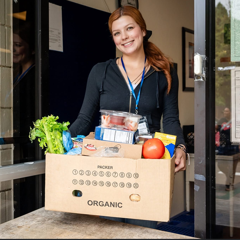 Fernanda Castaneda Ruiz holding a box of food.