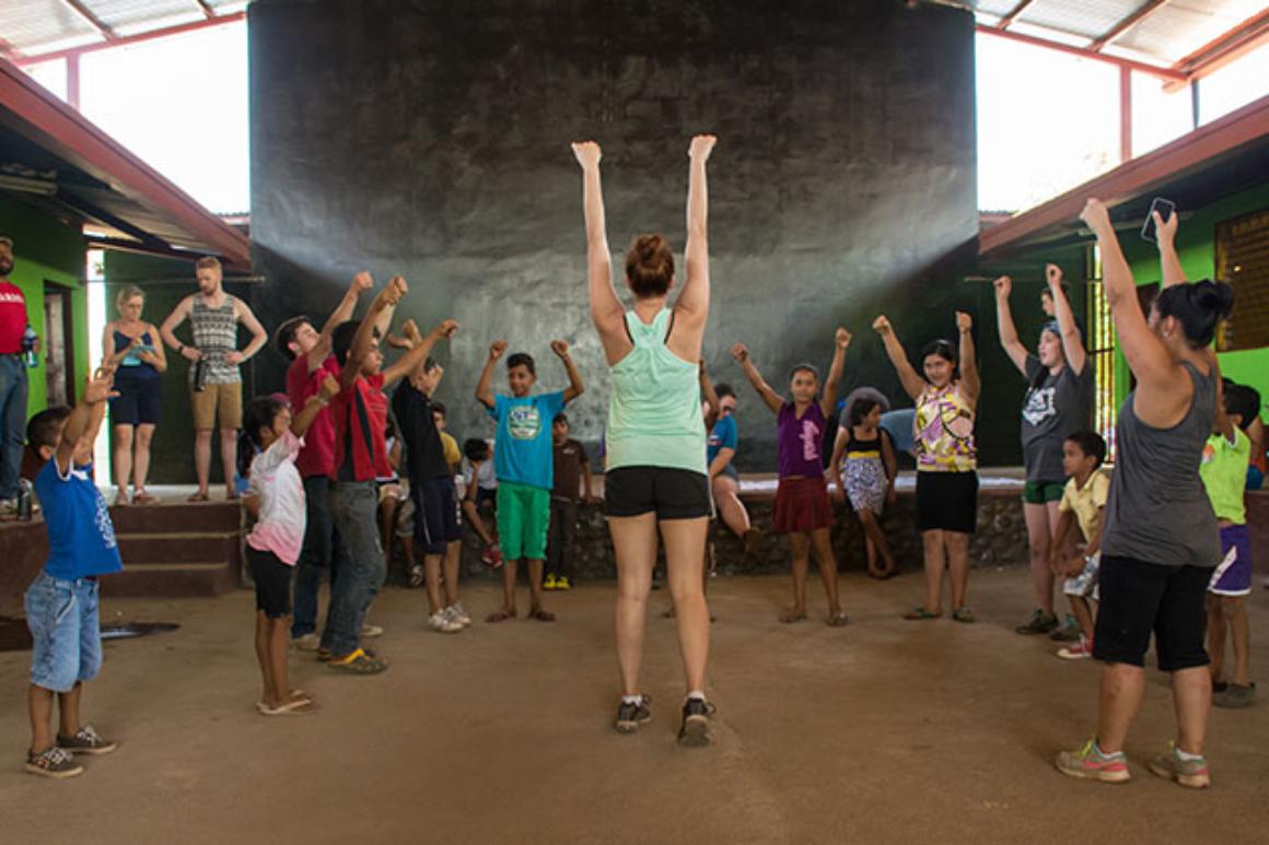 People standing in a theater with arms raised, titled Teatro Catalina 2017.