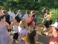 Students at at barn dance in a garden