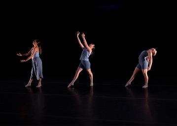 3 female dancers in pale blue side on to camera in different poses