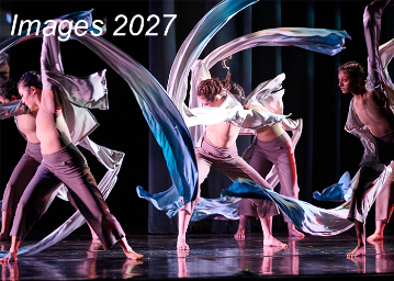 2 female modern dancers in white shirts and khaki pants whirling long white ribbons in circles 