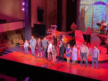 Director Karina Gutierrez joins her cast for the curtain call at Cruzar la Cara de la Lunas opening night