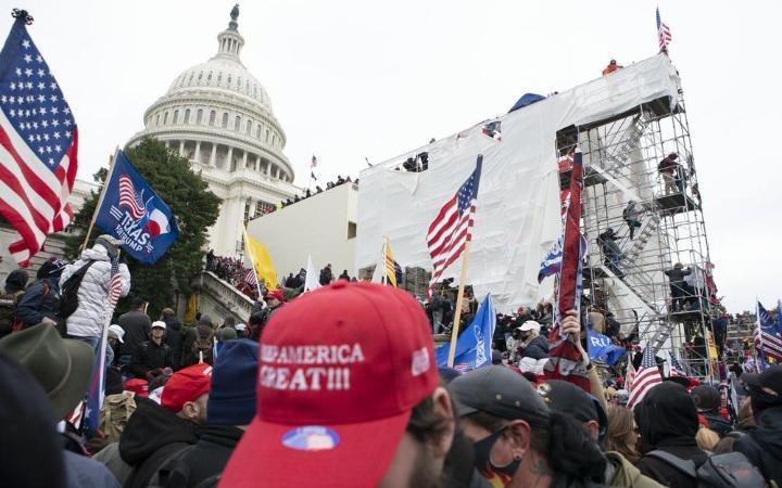 mob of Trump supporters protest and riot at US Capitol on Jan 6 2021