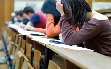 Students in a classroom taking an exam.