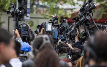 Press, cameras, crowd.