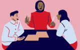 three people in disucssion at a table 