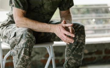 Close-up of a military veteran's hands in a therapy session, emphasizing mental health support. RDNE Stock Project via Pexels.