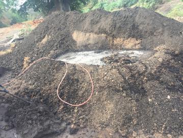 The watering of the clay brick mixture made in Nicaragua. The hose pictured below was left to run for hours at a time, which allowed the clay to reach a consistency that made it easier for them to mix and move into wooden brick molds.
