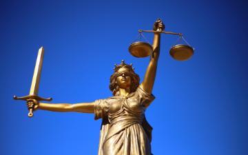 Statue of justice, blindfolded with sword and scales. 