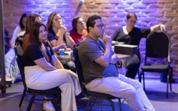 Attentive audience members listening during an indoor seminar or workshop. Matheus Bertelli via Pexels.