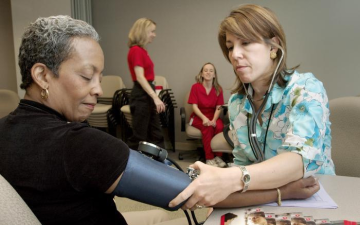 A blood pressure screening conducted during National Women’s Health Week highlights the importance of cardiovascular prevention and early detection among women. Image courtesy of the Centers for Disease Control and Prevention (CDC) Public Health Image Library (PHIL), ID #7865. Public domain.