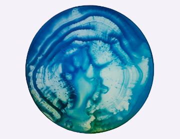 Abstract blue and green circular art resembling a planets surface. image link to story