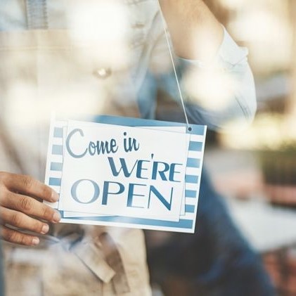 Store owner flipping come in were open sign