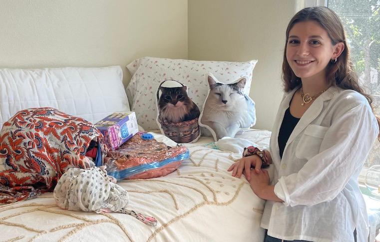 Giovanna Esposito 26 and her cat pillows in her room at Dunne Residence Hall.