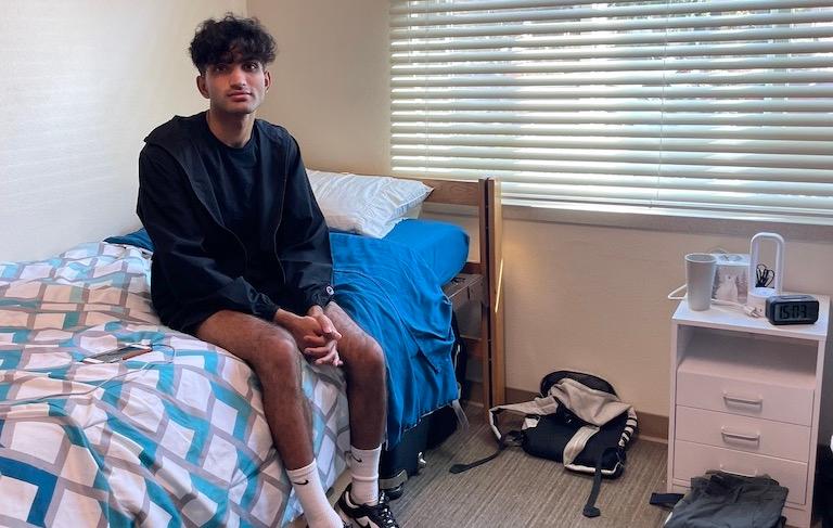 Ananth Menon 26 relaxes in his room at Dunne Residence Hall.