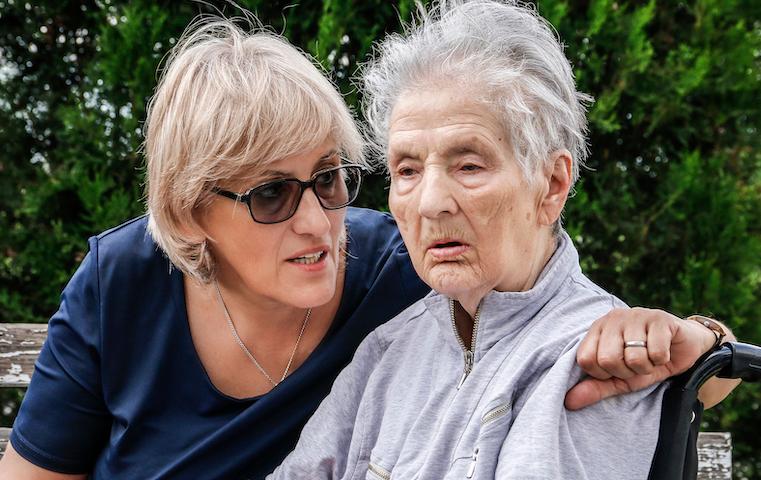 Photo of a woman talking to a loved one who has dementia