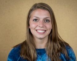 Alexa Desanctis Johnson Scholar smiling against a plain background.