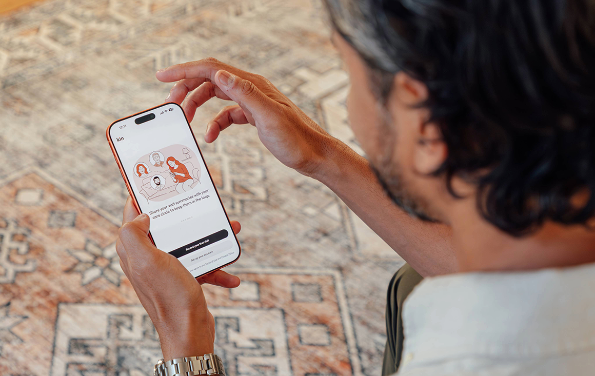 Man looks at Kin app on his iPhone
