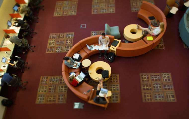 Library interior with curved seating and red carpet. image link to story