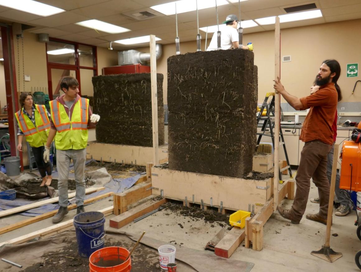 Mark Aschheims students building cob test walls in a SCU civil engineering lab; CRI board member Anthony Dente is at far right.