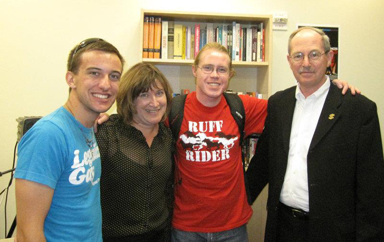 From left, RRC co-founder Kyle Arrouzet 13, Jeanne Rosenberger, Vice Provost for Student Life & Dean of Students, RRC co-founder Devin Wakefield 13 and Michael Engh, S.J., during the grand opening of the Rainbow Resource Center in 2011.