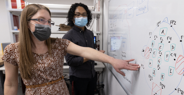 Julia Scott, senior research associate in SCUs Bioinnovation and Design Lab, discusses prototype calculations with electrical engineering major Michael Bose 22.